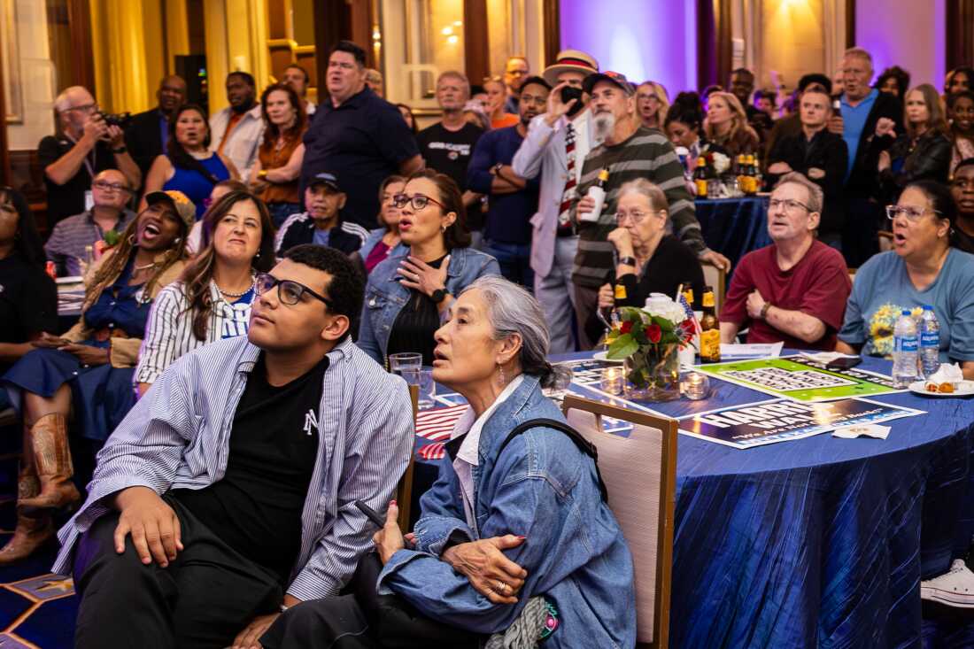 Attendees react as a race is predicted for Trump during the Travis County Democratic Party’s Election Night watch party in Austin, Texas.