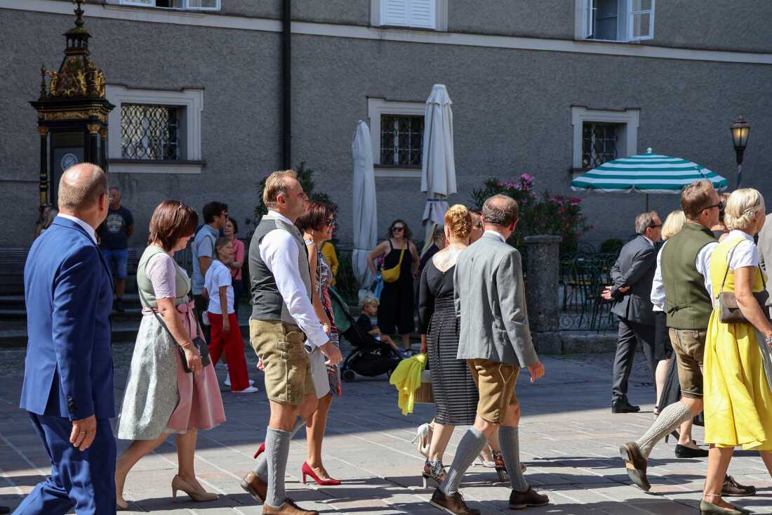 Salzburg Festival attendees walk through the historic city center as they head to the opening ceremony.