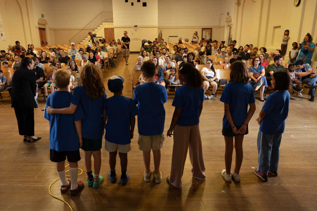 Principal Nichole Sakellarion greets families new to Micheltorena Street Elementary School and introduces some of the fifth-grade “toolbox coaches” who will mentor kindergarteners throughout the school year.