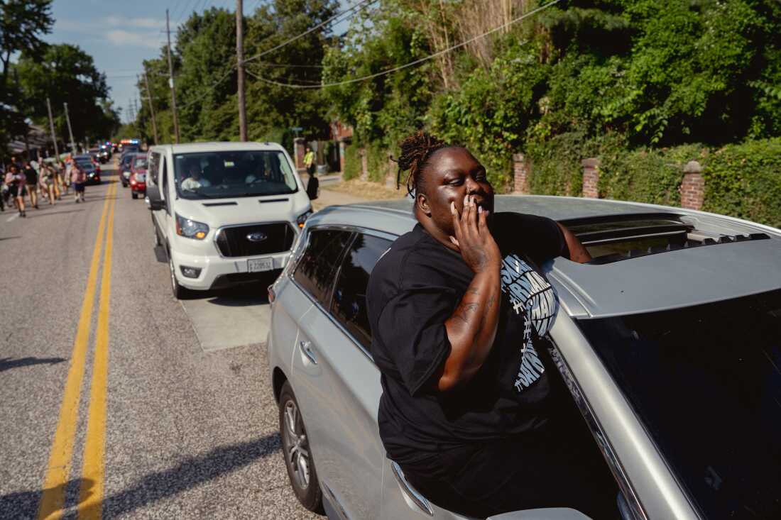 Ebony Williams, 33, of The Ville, yells out “say his name!” on Friday, Aug. 9, 2024, during a unity march commemorating a decade after Michael Brown Jr.’s police killing in Ferguson.