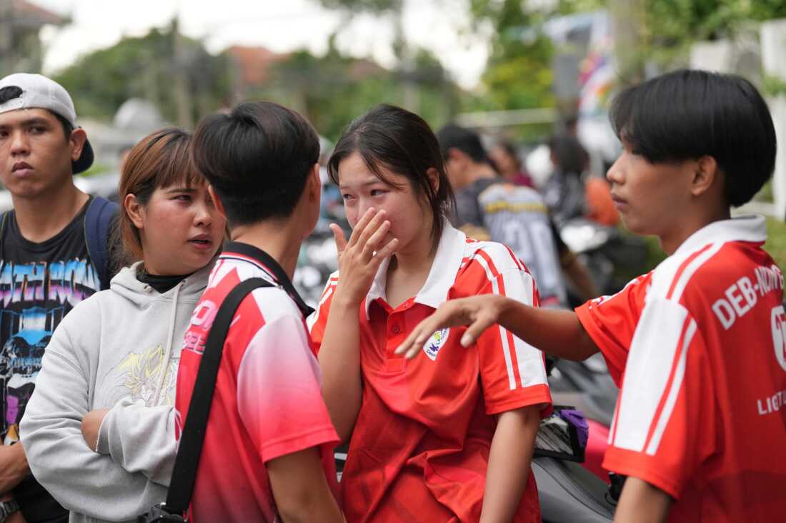 A schoolgirl cries outside her school where deaths and injuries were reported after a shooting in Thailand's Nonthaburi province, Friday, Aug. 7, 2026.