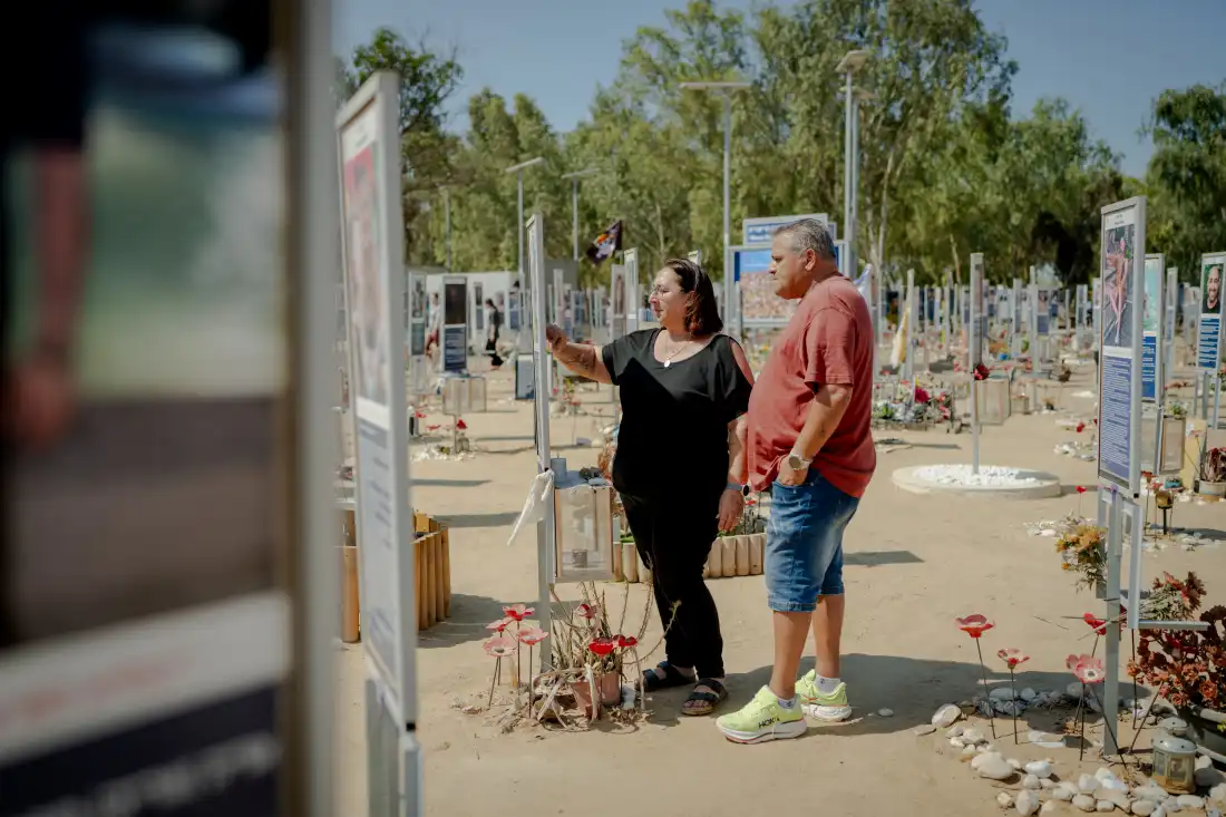Meir and Kati Zohar stand together at the memorial marker dedicated to their daughter, Bar Zohar, surrounded by hundreds of commemorative signs at the Nova festival site near Kibbutz Re'im, southern Israel, on Sept. 24, 2026. Their daughter was among the victims killed during the Hamas-led attack on Oct. 7, 2023.