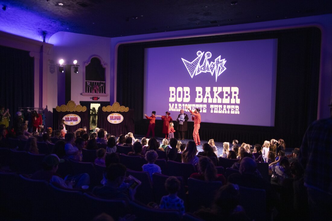 Performers with the Bob Baker Marionette Theater gesture to the crowd of families at Vidiots, a historic theater in northeast Los Angeles, a few miles from where fires are still burning in the Altadena and Pasadena neighborhoods.