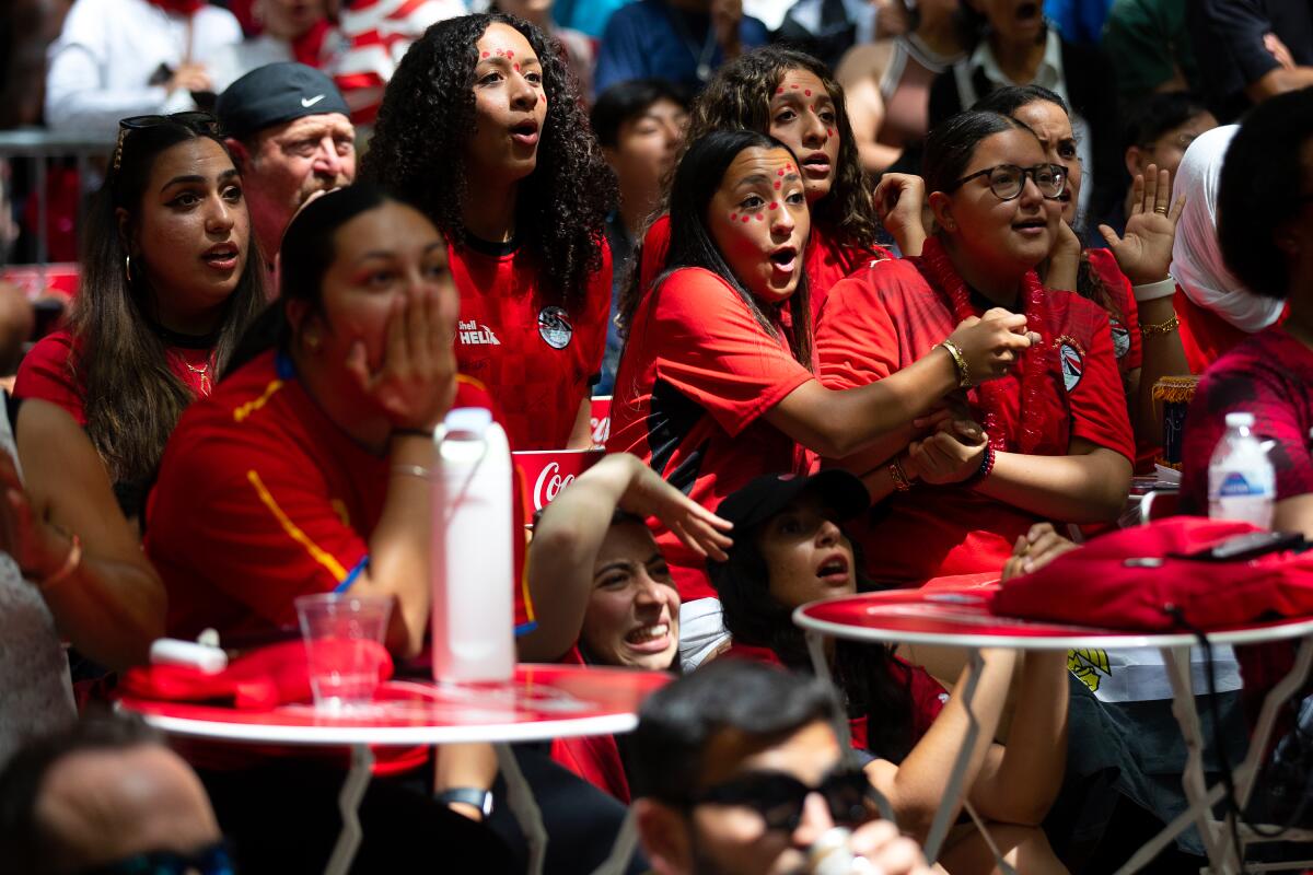 Soccer fans rooting for Egypt, including Mennatalla Namatalla (center), who was born in Cairo, react to the game's suspense during the FIFA World Cup match against Belgium at a watch party on Monday, June 15, at Occidental Square in Seattle's Pioneer Square neighborhood.