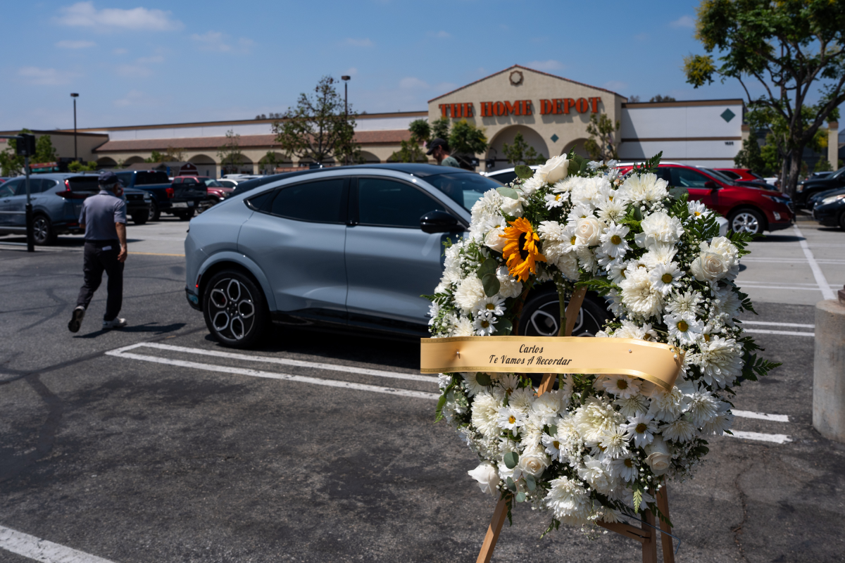 A wreath for the late Carlos Roberto Montoya, a 52-year-old man from Guatemala, is placed in the parking lot of Home Depot in Monrovia, Calif. Montoya died after being hit by a car on the freeway as he was fleeing from an immigration raid outside the store.