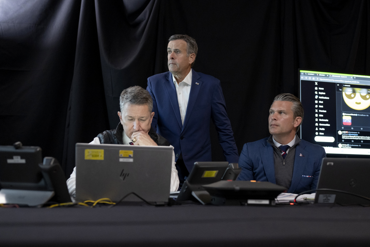 In an image provided by the White House, Chairman of the Joint Chiefs of Staff Gen. Dan Caine, left, CIA Director John Ratcliffe, center, and Secretary of Defense Pete Hegseth, right, monitor U.S. military operations in Venezuela on Jan. 3 from President Trump's Mar-a-Lago club in Florida. On Hegseth's right is a display featuring a search for 'Venezuela' on the social media platform X.