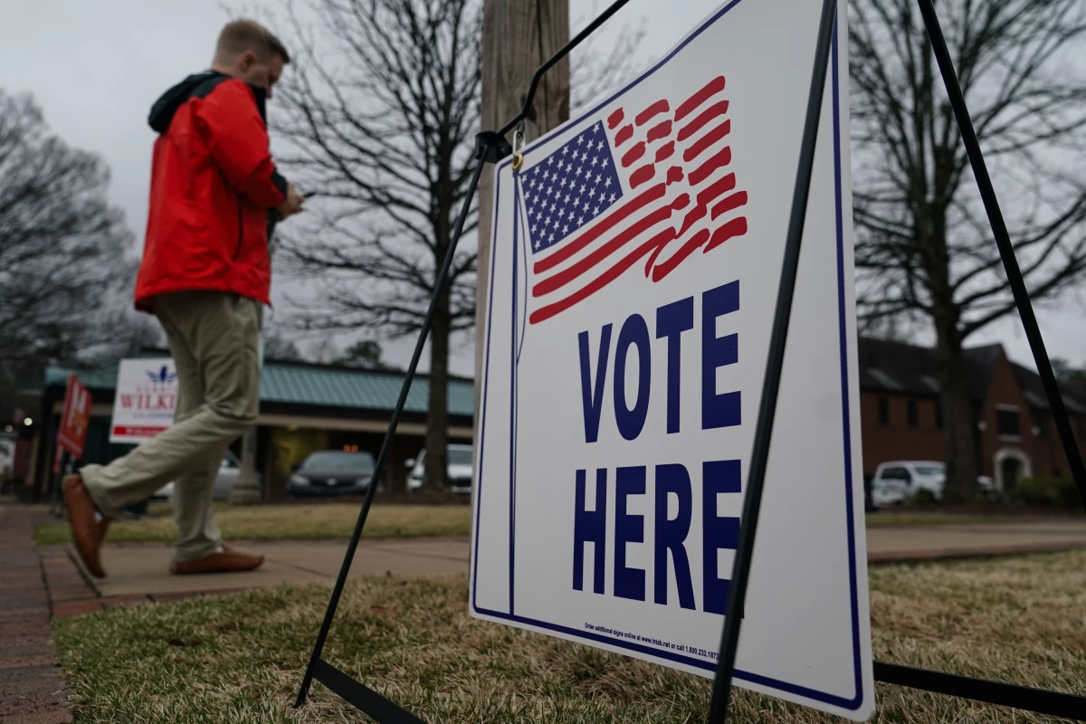 A voter walks toward a polling place to cast their ballot for Alabama’s March primary election in Mountain Brook, Ala.