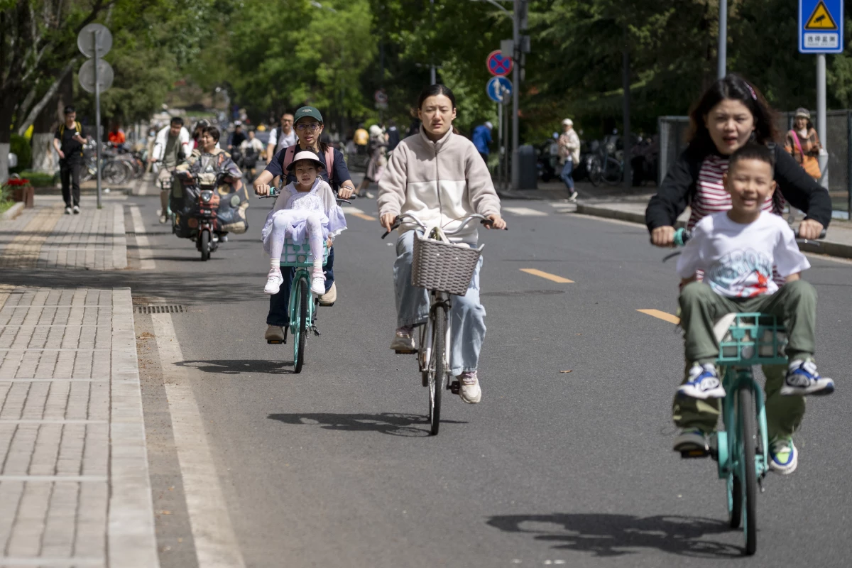 People cycling in Tsinghua University in Beijing, China on April 23, 2024.