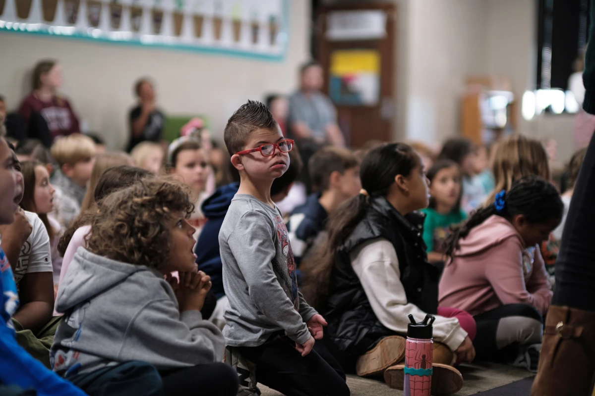 Kellen and his peers start their day with a morning huddle.