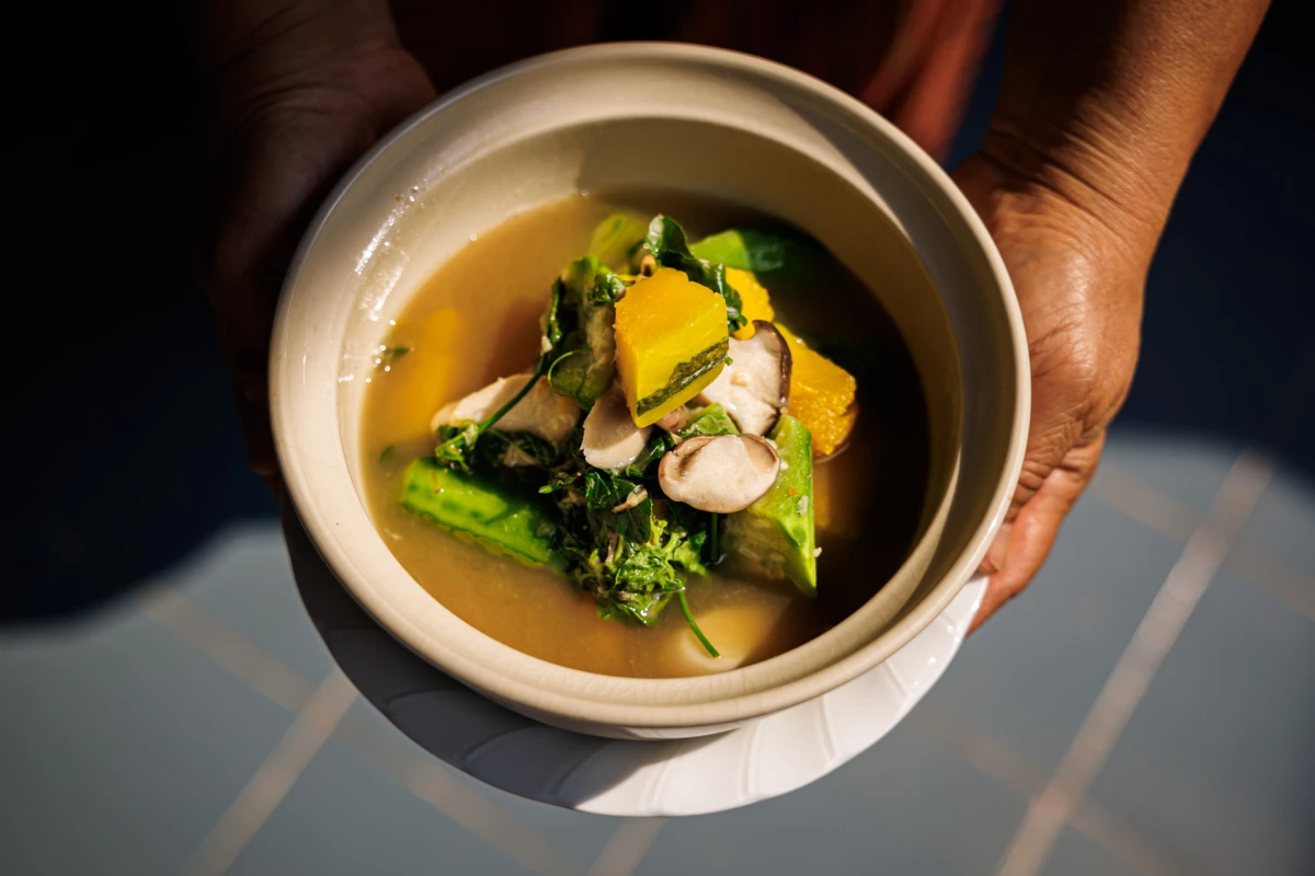 In Bangkok, Hnoi Lathitham, 57, holds a bowl of gang liang — a soup she ate weekly while growing up.