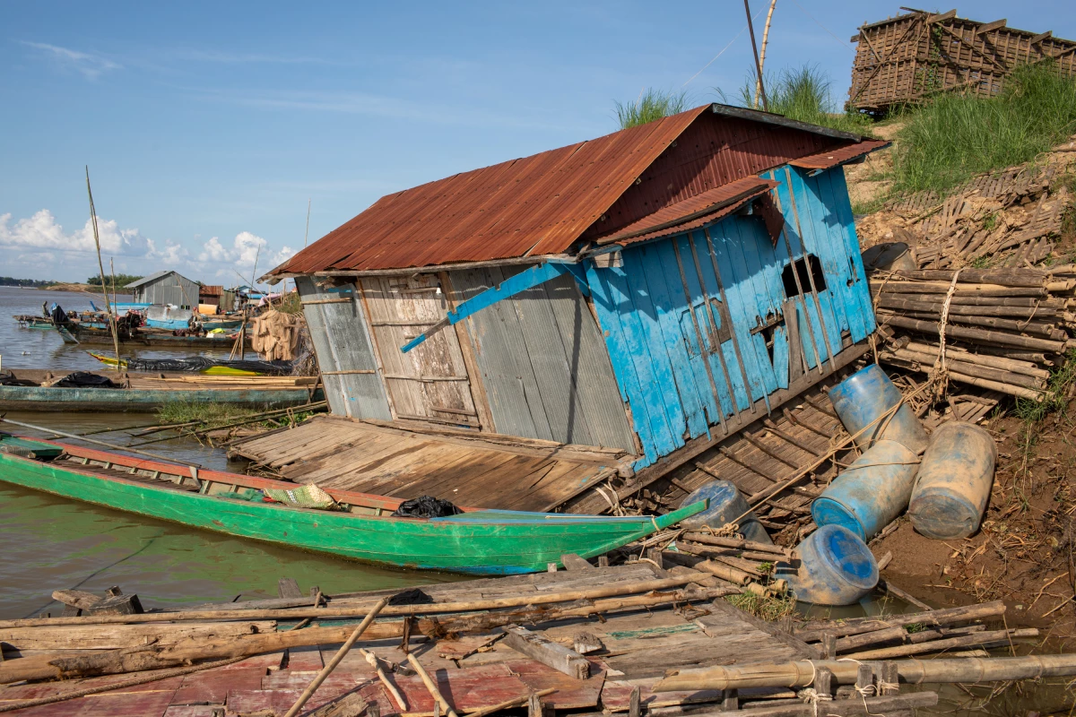 Docks, boats and a building were all smashed by flooding near the city of Kampong Cham in 2025. Most local residents evacuated before the water arrived.