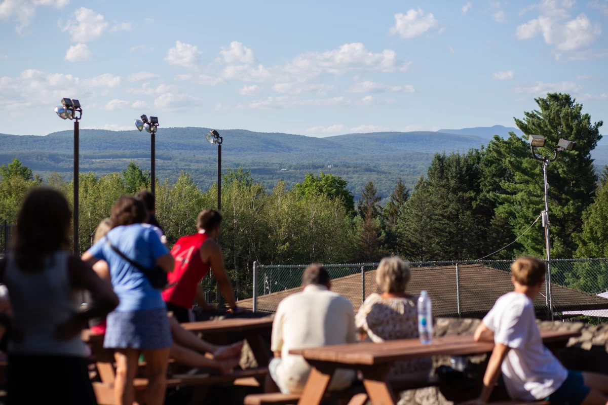 Volleyball spectators enjoy the action below while the surrounding mountains provide the perfect backdrop, reminding Soyuzivka’s founders of their beloved Carpathian Mountains.