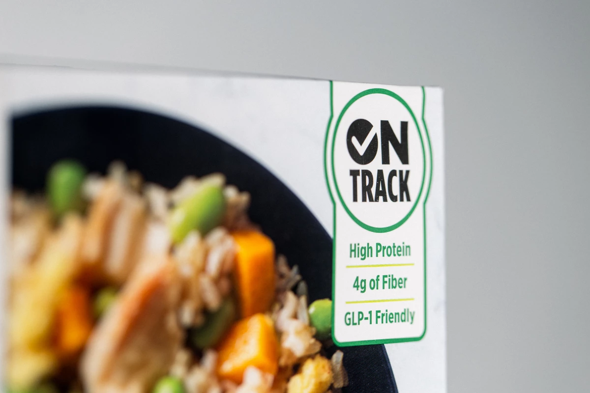 A close-up photo of the 'On Track' label on the box of a Healthy Choice frozen dinner marketed to people on GLP-1 drugs, which include Ozempic, Wegovy, Zepbound and Mounjaro.