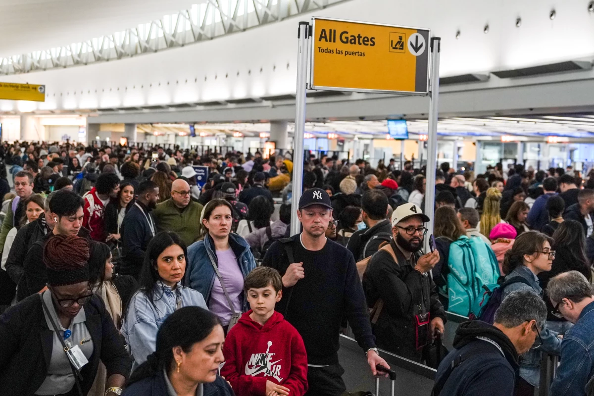 People wait in long TSA security lines at John F. Kennedy International Airport (JFK) in the Queens borough of New York, Monday, March 23, 2026.