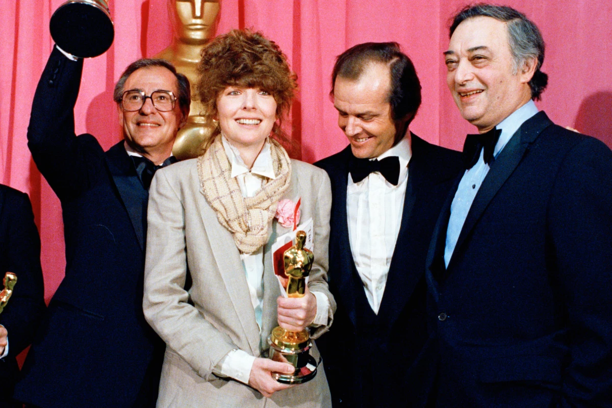 FILE - Oscar winners Charles H. Joffe, winner of best picture for 'Annie Hall,' left, and Diane Keaton, winner of best actress for 'Annie Hall,' poses with presenter Jack Nicholson, and producer Jack Rollins at the Academy Awards in Los Angeles on April 3, 1978.