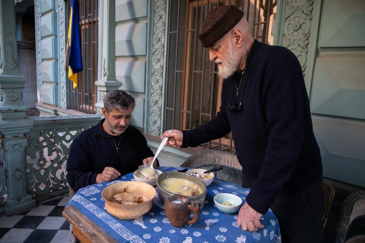 David Sulakauri, the photographer's father, serves the soup. An artist in Georgia, he also loves to cook. One of his favorite dishes is khashi, a soup believed to have healing powers.