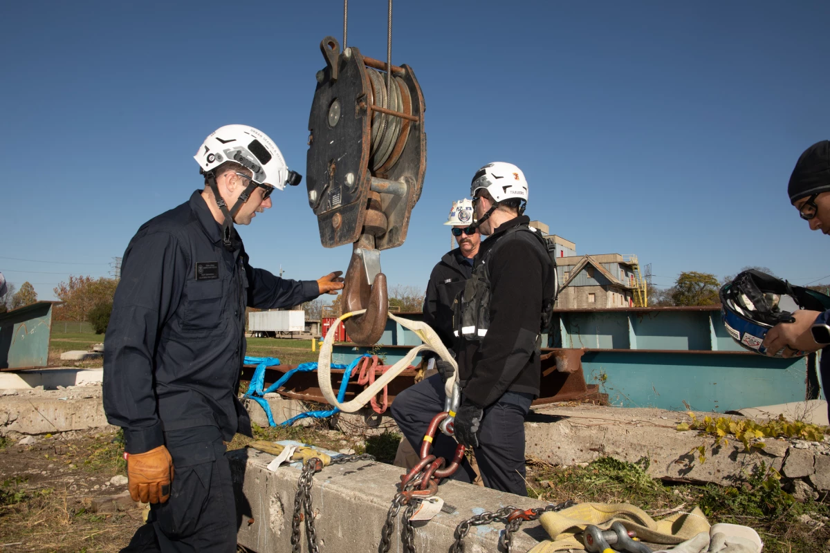 Search and rescue experts practice attaching a piece of concrete to a crane so it can be lifted out of the way during a training in Ohio. The goal of the exercise is to simulate the actual experience of rescuing people, whether it's from a collapsed building or a pile of debris after a flood, hurricane or wildfire.