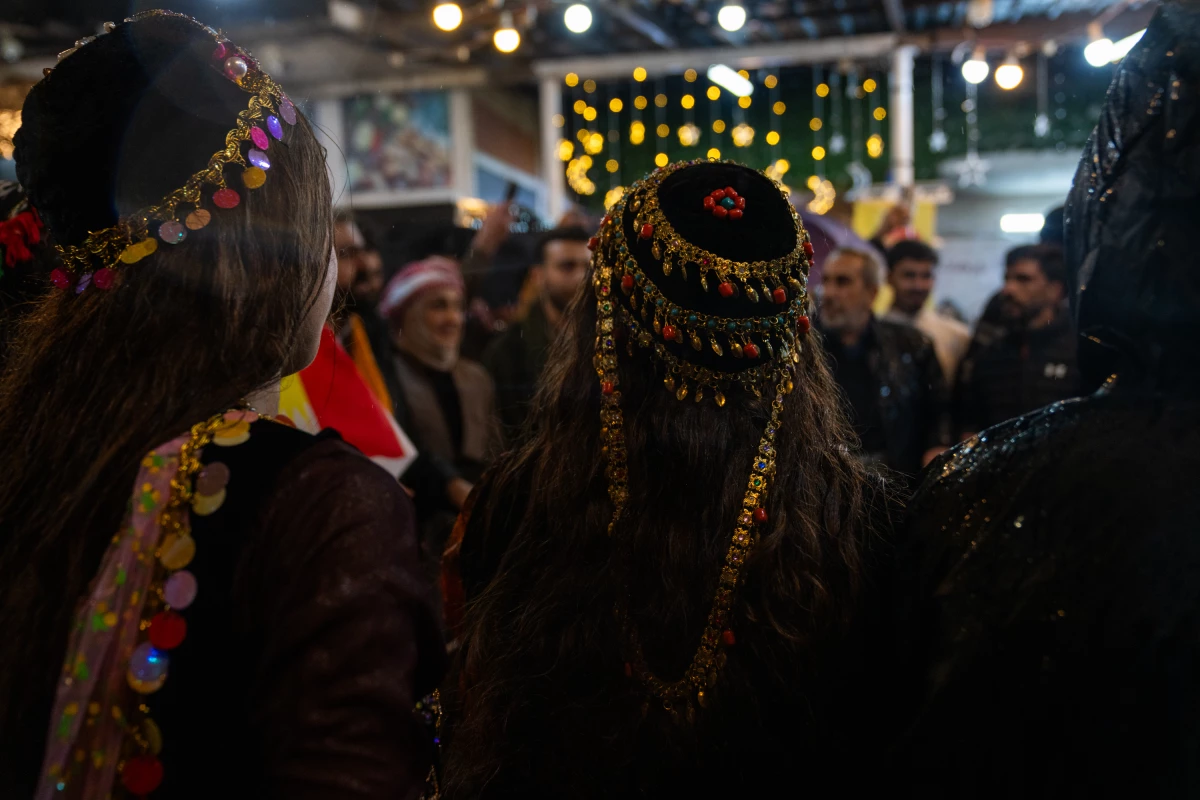 Women wear Kurdish headdresses on Friday while gathering in the city's plaza.