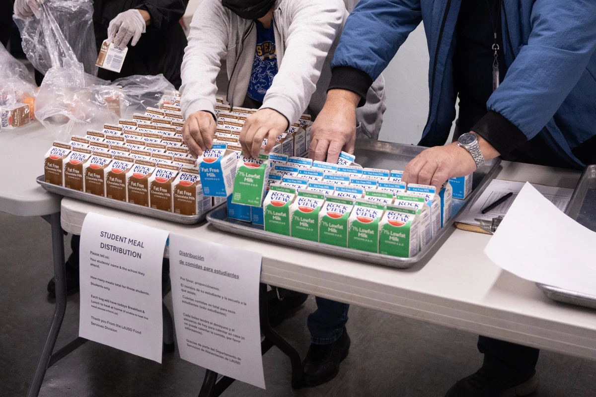 Workers assemble bags for families to pick up. Each one includes breakfast and lunch.