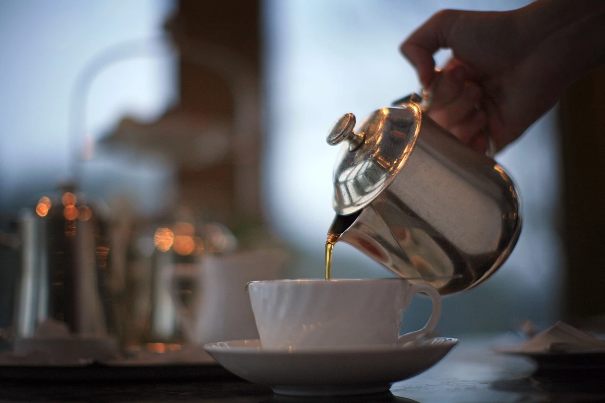 A server pours tea at Bettys tearoom at Harlow Carr, in Harrogate, England, on Feb. 12, 2009.