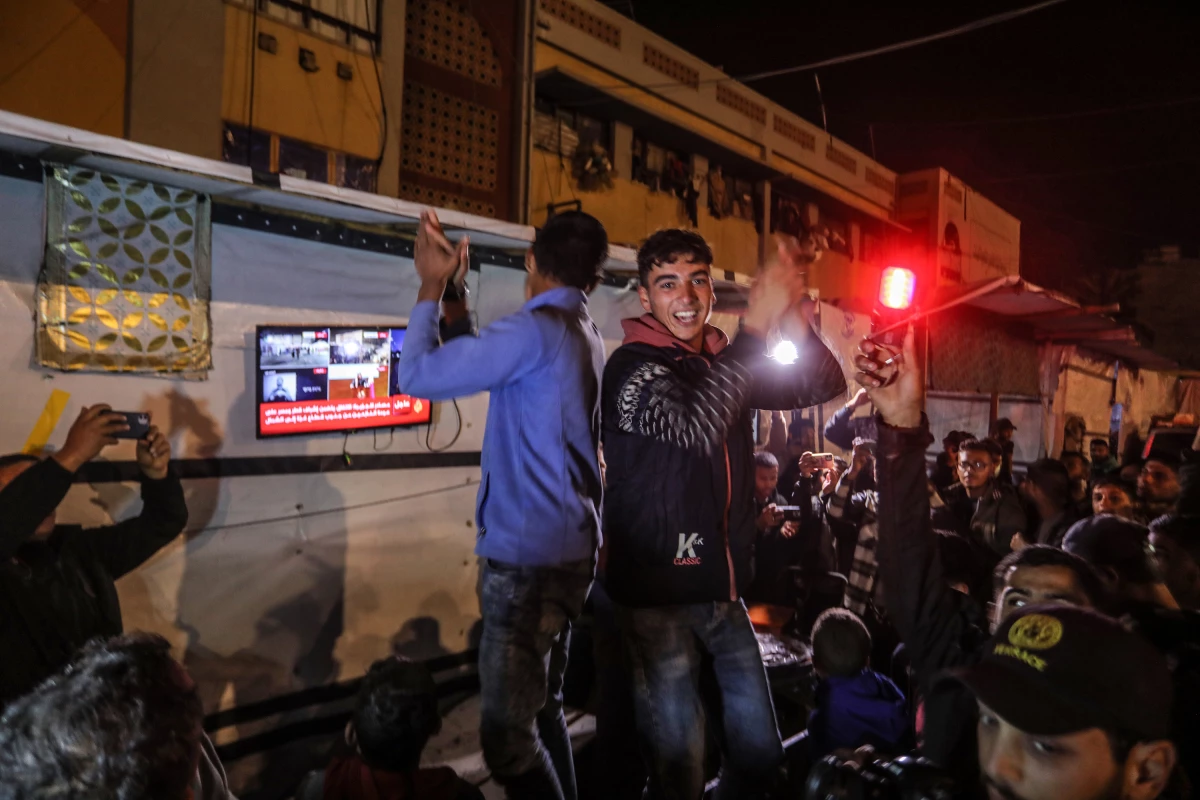Palestinians celebrate in the southern Gaza city of Khan Younis after U.S. President-elect Donald Trump's announcement of hostage deal between Israel and Hamas on Wednesday.