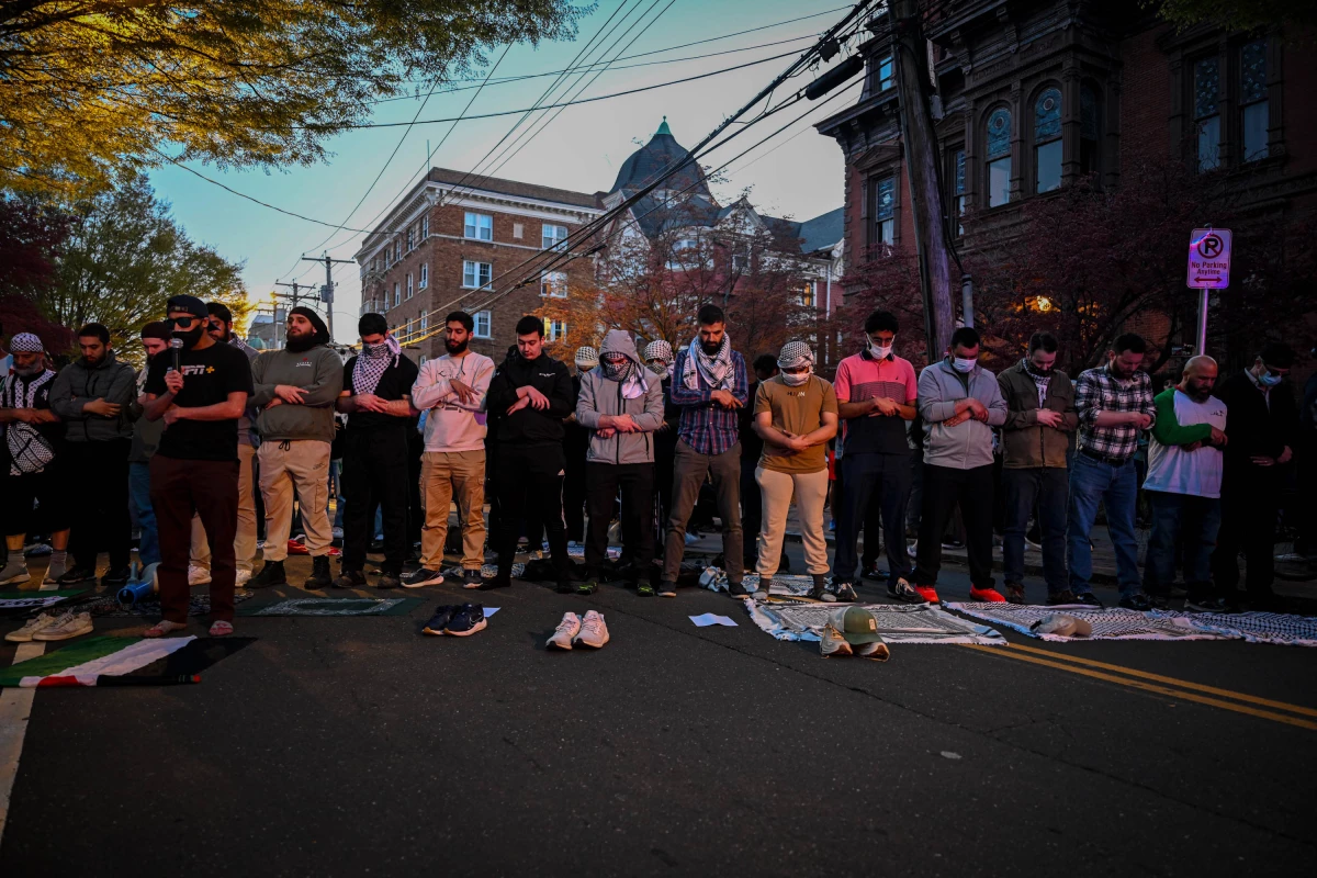Pro-Palestinian activists pray in the streets as part of a protest against the presence of Itamar Ben-Gvir, the Israeli Minister of National Security, outside the John C. Anderson House on the Yale University campus in New Haven, Conn., on April 23, 2025.