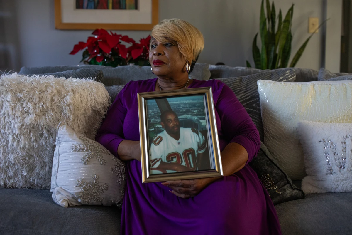 Melinda Mattocks-Ushry holds a photo of her brother Kelvin “Chuck” Mattocks at her home in New Bern, N.C., on Dec. 5, 2023.