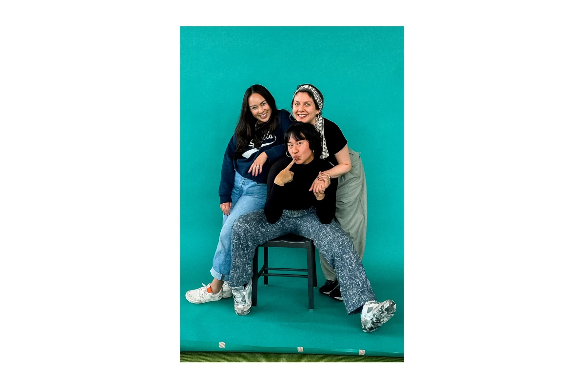 Cirino (center) embodies a seated version of the wide-leg 'power pose.'