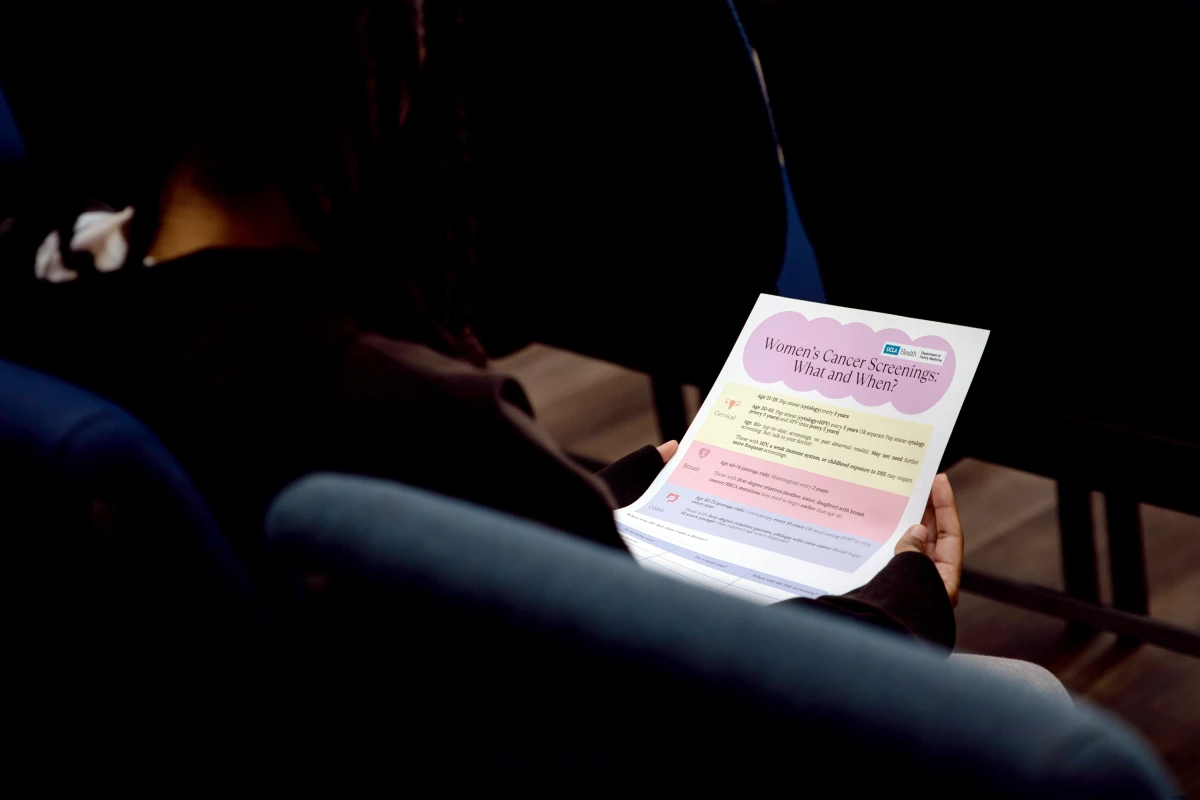 A resident at the Union Rescue Mission reviews a flyer providing information on different types of cancers and their risks. December 15, 2025