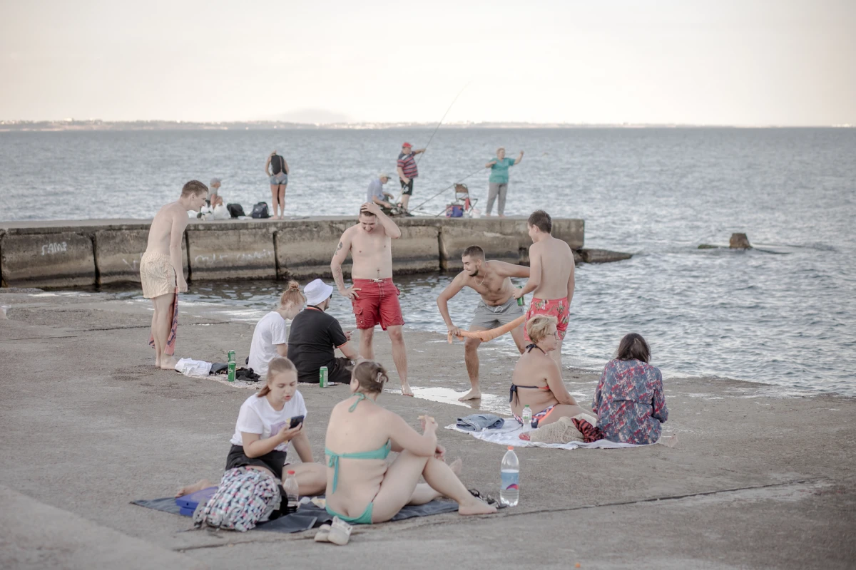 Odesa's beaches are often so crowded that people also spread out onto the nearby concrete 'beaches' to enjoy time by the sea.