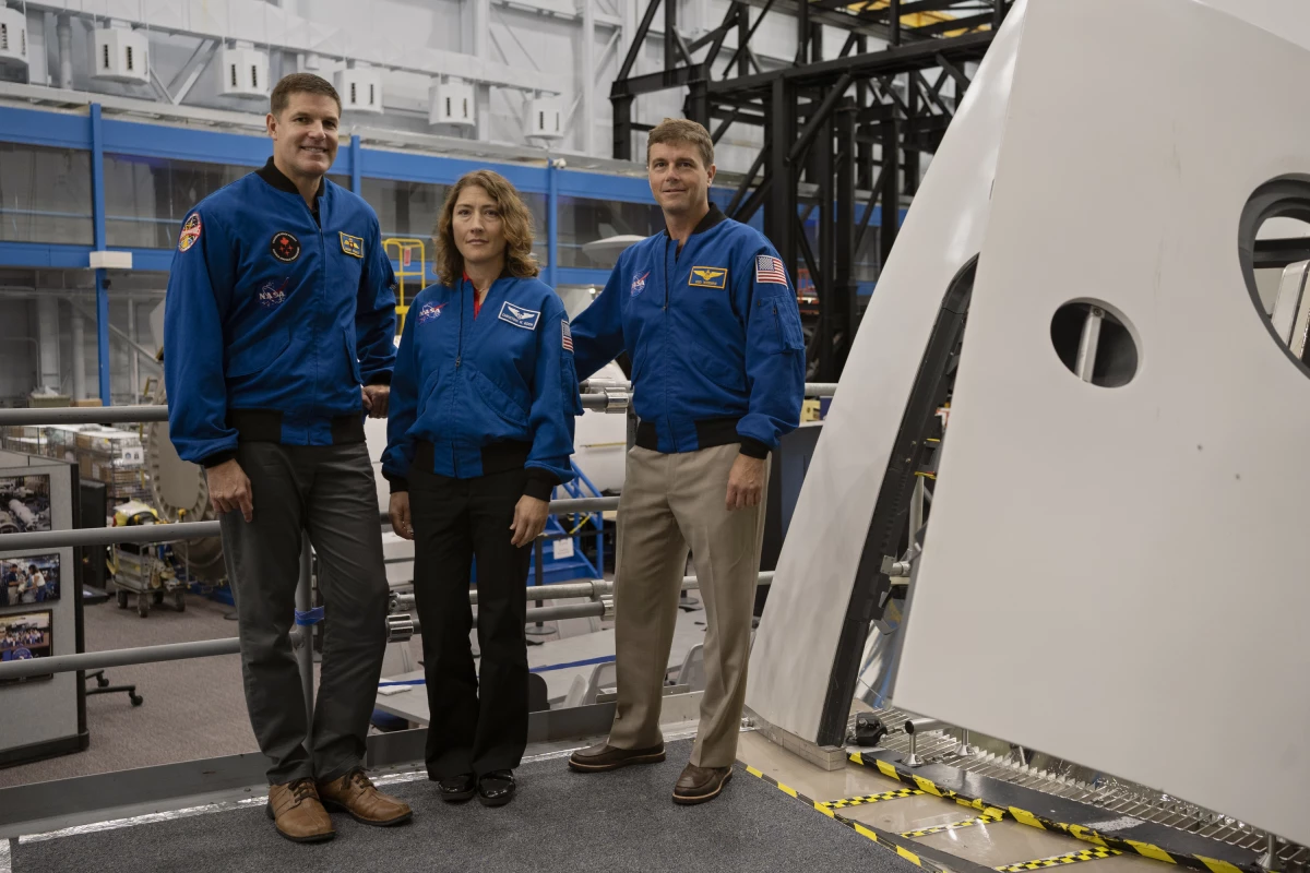 From left to right: Astronauts Jeremy Hansen, Christina Koch and Reid Wiseman with the Orion spacecraft mockup.