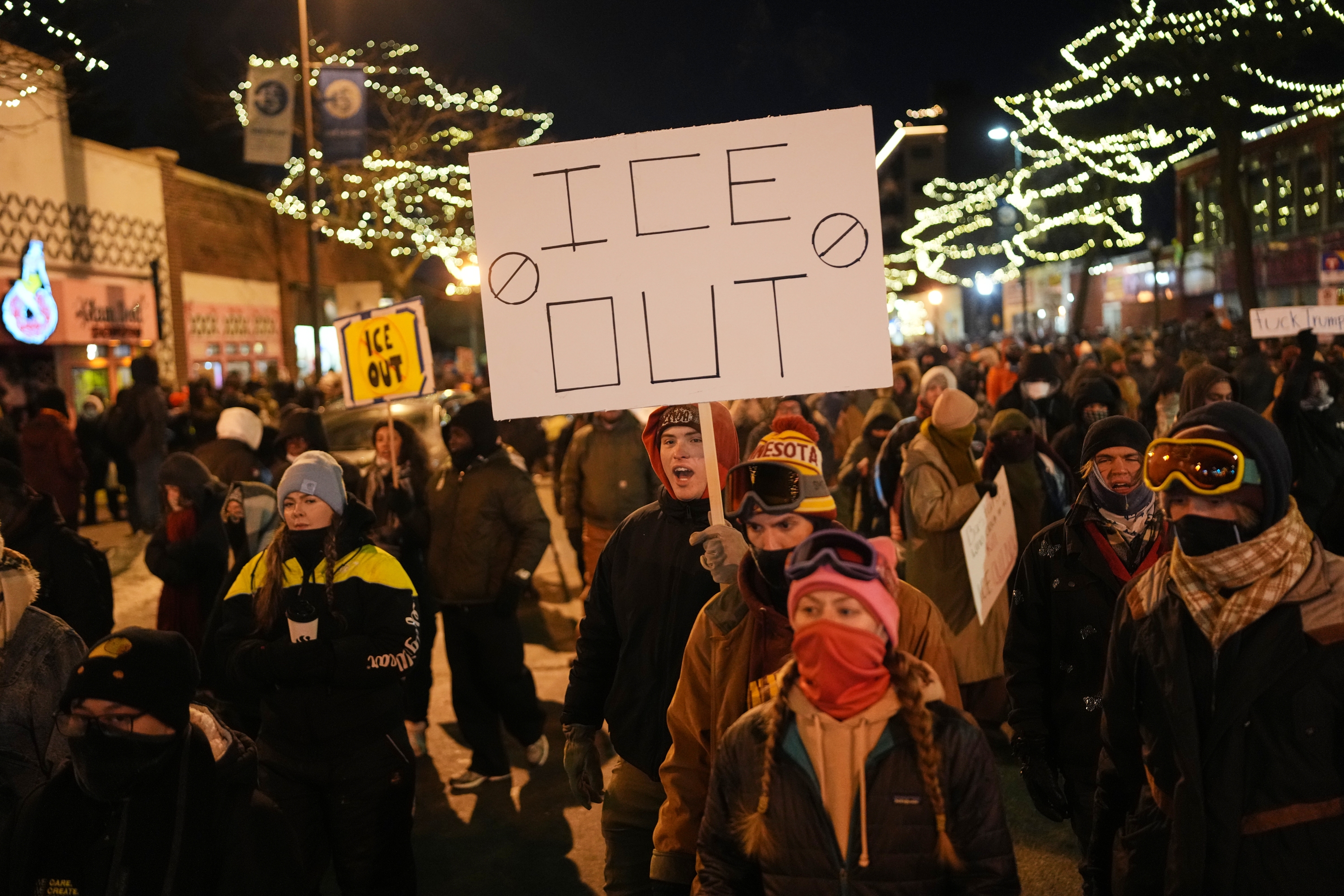 A person holds a sign during a vigil for 37-year-old Alex Pretti, who was fatally shot by a U.S. Border Patrol officer earlier in the day on Saturday in Minneapolis. (AP)