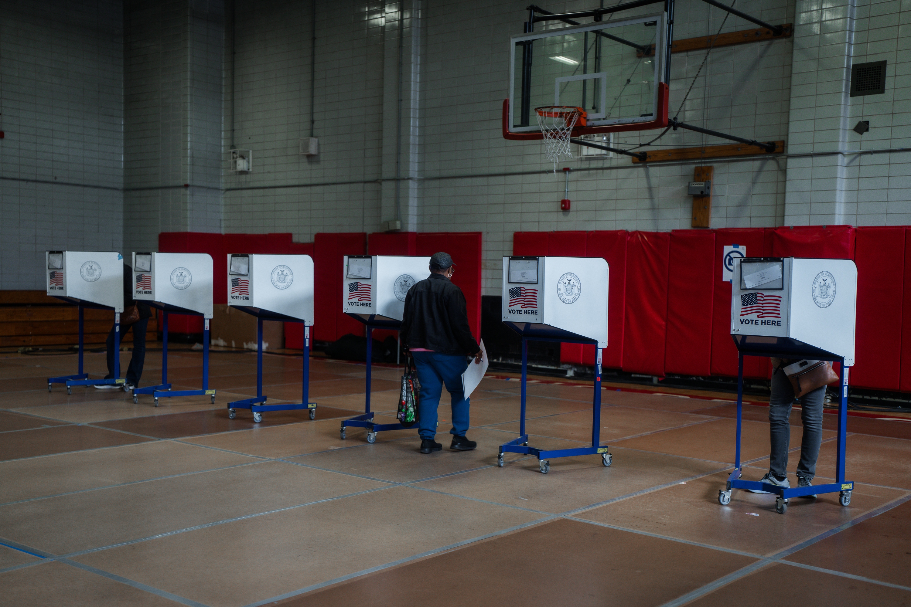A voter carries a ballot during early voting for New York City