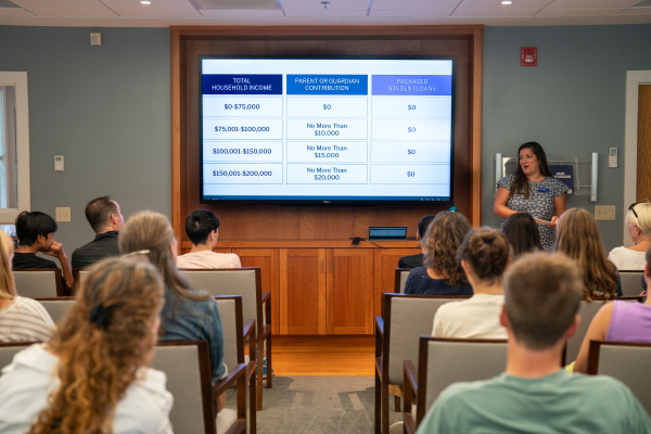 Lexi Summer, the director of enrollment marketing and communications at Colby, gives a welcoming presentation to families.