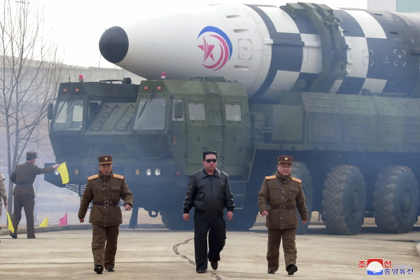 In this photo distributed by the North Korean government, North Korean leader Kim Jong Un, center, walks near what it says is a Hwasong-17 intercontinental ballistic missile (ICBM) on the launcher at an undisclosed location in North Korea on March 24, 2022.