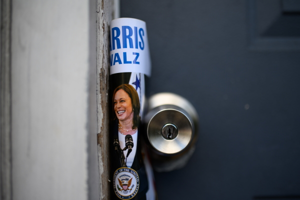 A Harris-Walz pamphlet is left on a door as Service Employees International Union members canvass Latino voters in Philadelphia on Sept. 22.
