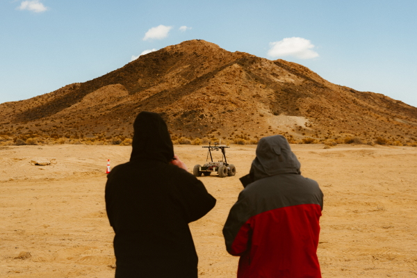 Two people admiring the Helelani rover.