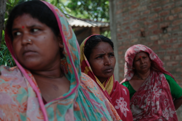 Women in the village of Sandeshkhali in the Indian state of West Bengal in May 2024. The women say their lands were seized by a local strongman who broke the dyke that protects their low-lying land from saline sea water, destroying their rice paddies and rendering the land infertile. The man then converted the lands into a shrimp ponds.