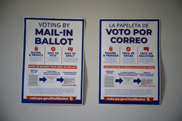 Signs about mail voting are pinned to a wall in the offices of civic engagement organization Ceiba in the Norris Square neighborhood of Philadelphia on Sept. 20.