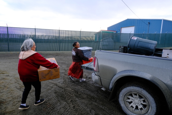 Volunteers Kaitlin Andrew and Angie Walter handle flood relief donations at the Bethel Search and Rescue building on Oct. 14, 2025.