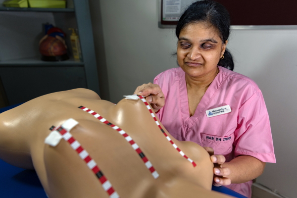 Meenakshi Gupta, who is blind, works as a "medical tactile examiner" to identify breast tumors. The dummy is used in the training program for would-be examiners.