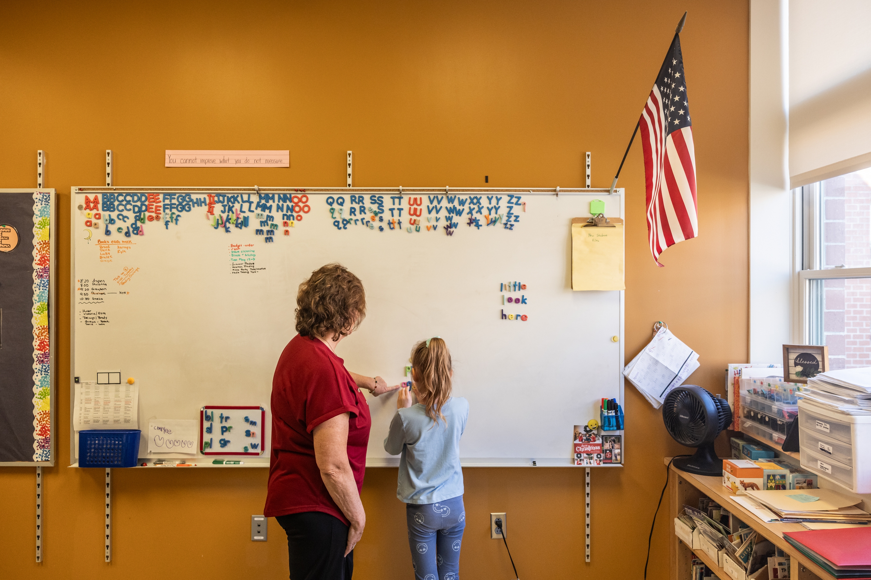 Reading interventionist Roxanne Davis works with a first grader on forming words at Mill Stream Elementary School.