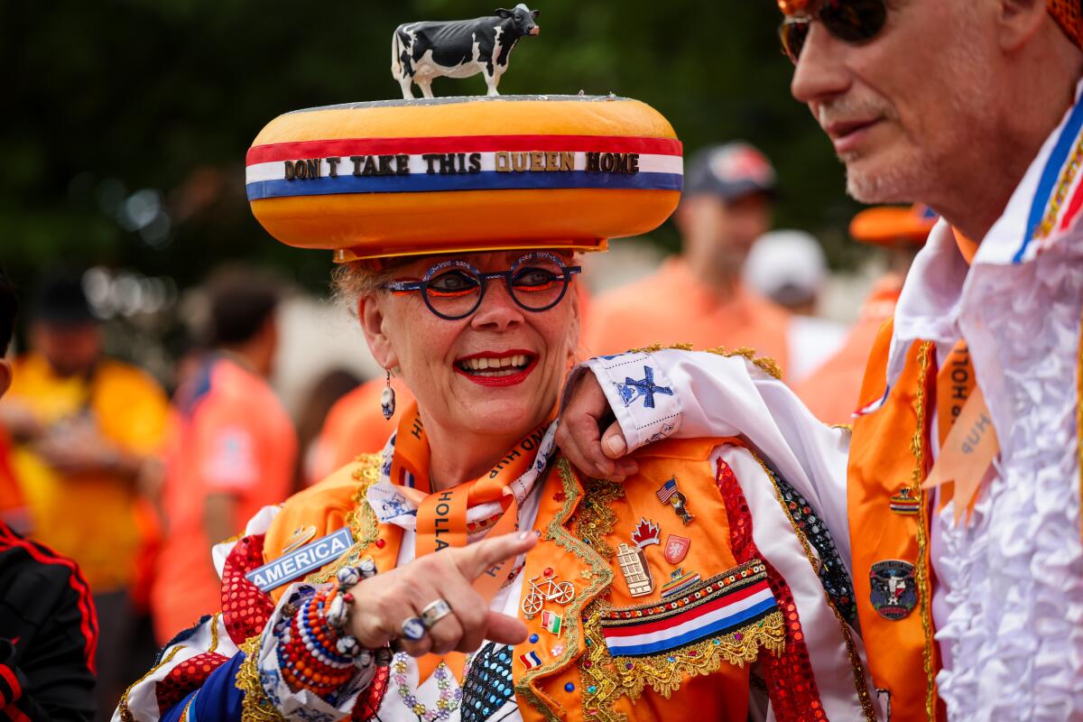 Juydo Janssen and 'The Queen of Cheese' dressed up in modified Dutch traditional outfits to symbolize the Netherlands before the team's World Cup match against Japan on Sunday, June 14, in Arlington, Texas.
