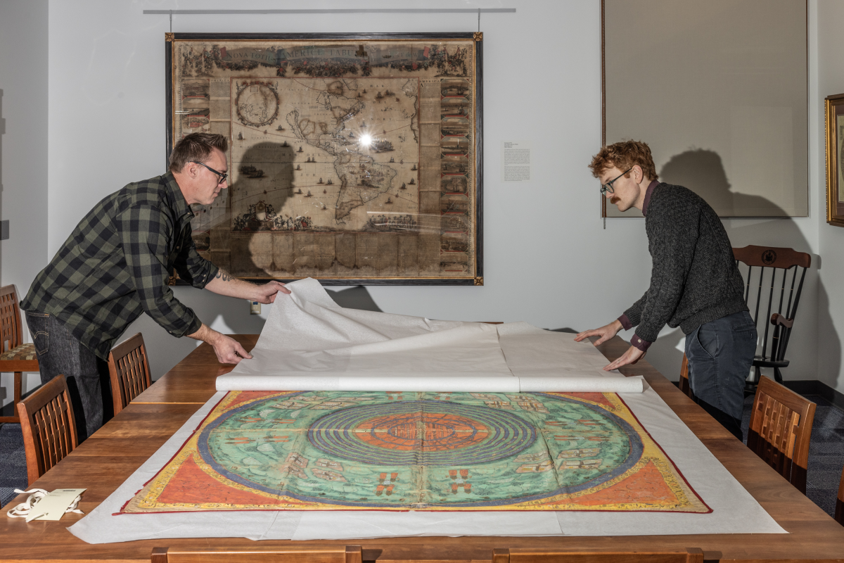 David Neikirk, Digital Imaging Coordinator, left, and Paul Fuller, Coordinator of Digital Collections and Digital Initiatives, right, with a newly-acquired Jain Cosmology Map from India from 1830.