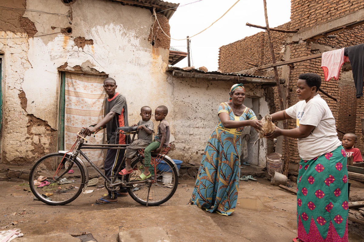 A household chicken slipped from the hands of its owner and a neighbor comes to the rescue in Kinama, Burundi. The chicken's owner is sitting on the bicycle with her two children, getting ready to go shopping. Says the photographer: 'Through this spontaneous gesture of returning a chicken, we feel the human warmth and mutual aid that unite the residents of Kinama. It is an image that speaks of community, kindness and the beauty of life's little moments.'