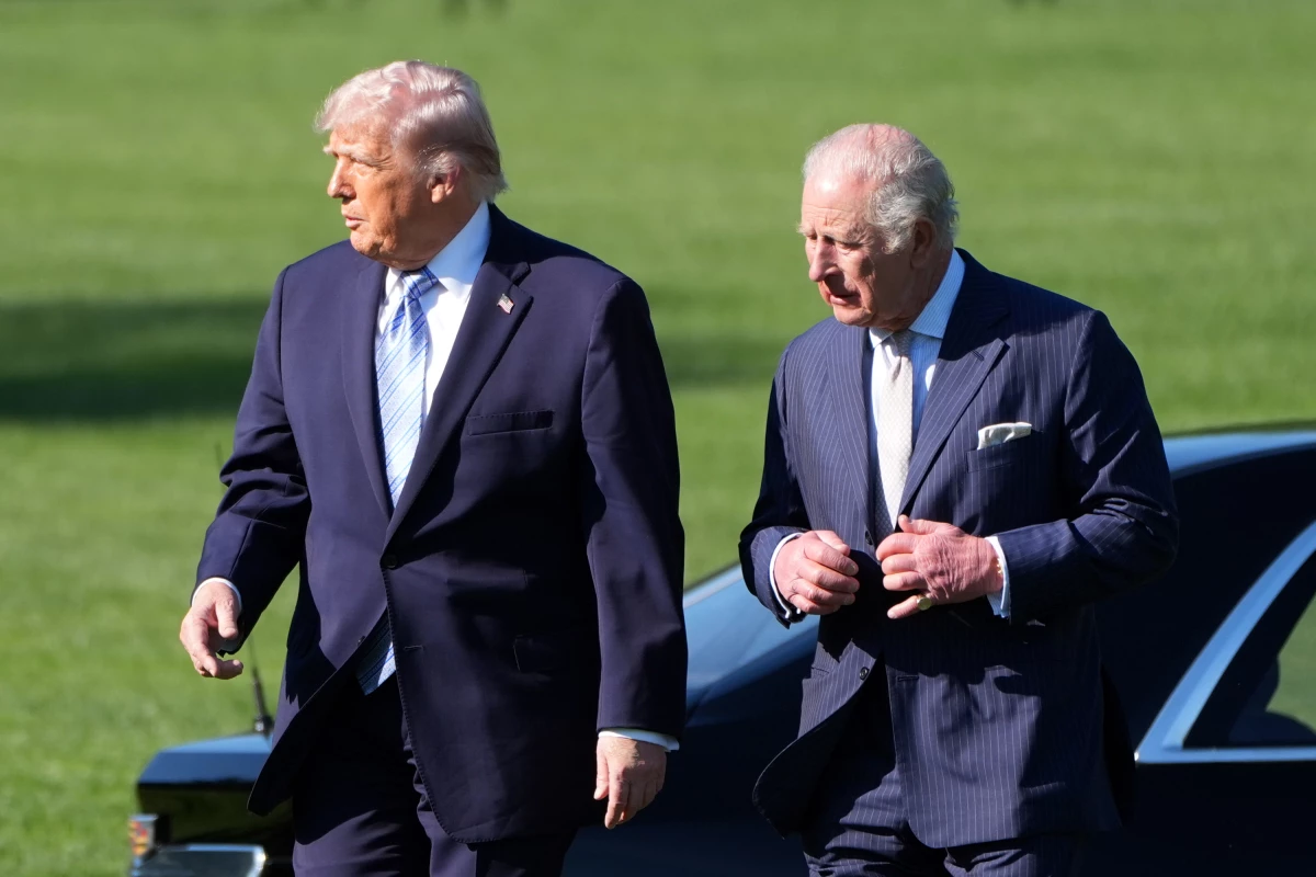 U.S. President Donald Trump and King Charles III arrive to look at the White House garden and bee hive on the South Lawn of the White House.