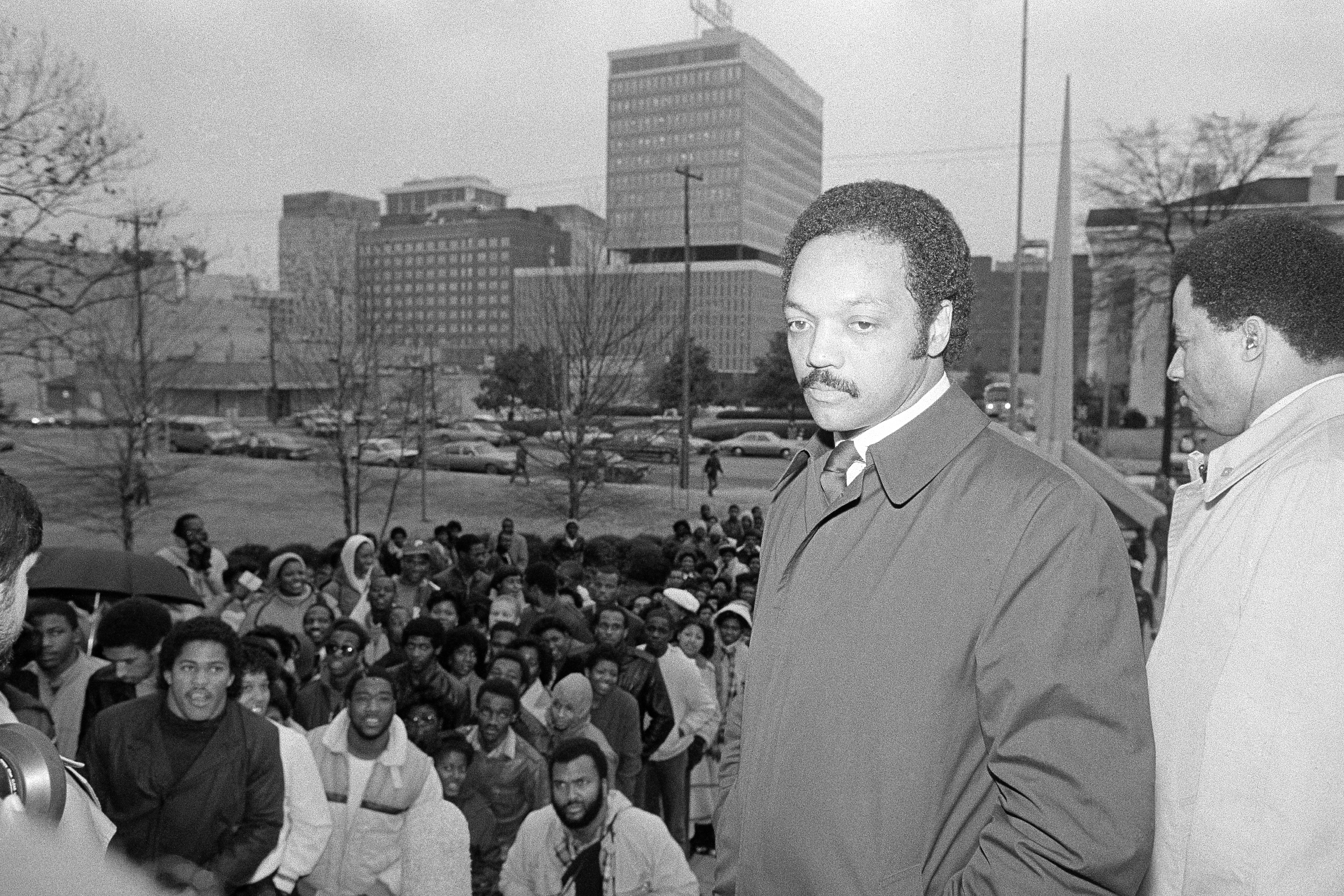 The Rev. Jesse Jackson stands on the steps of the Hinds county courthouse in Jackson, Mississippi, Tuesday, Jan. 17, 1984 after leading a large groups students and supporters from the Jackson State University campus to the Courthouse to register voters.