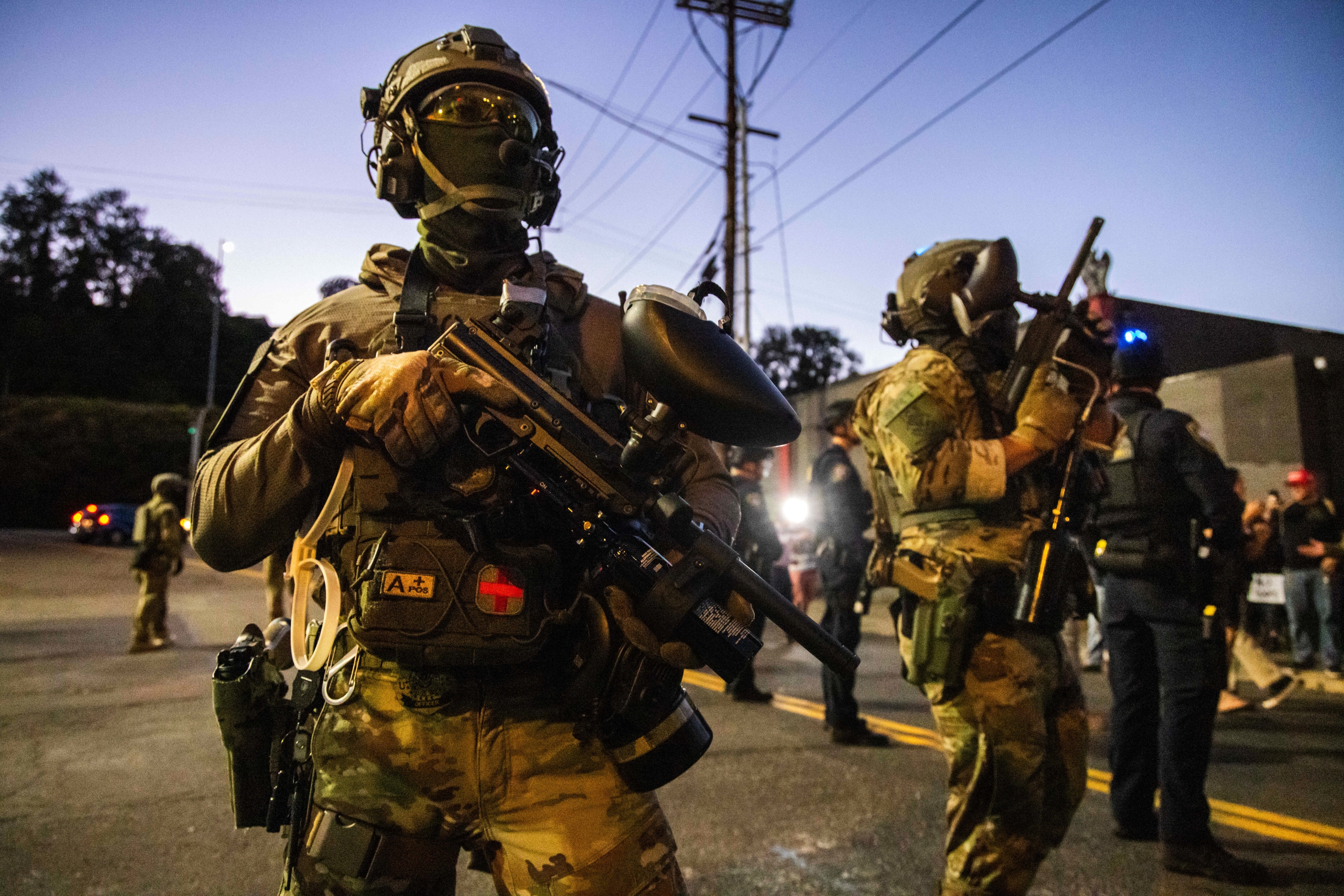 Federal enforcement officers stand guard near a U.S. Immigration and Customs Enforcement facility in Portland, Ore., Monday, Oct. 6, 2025.