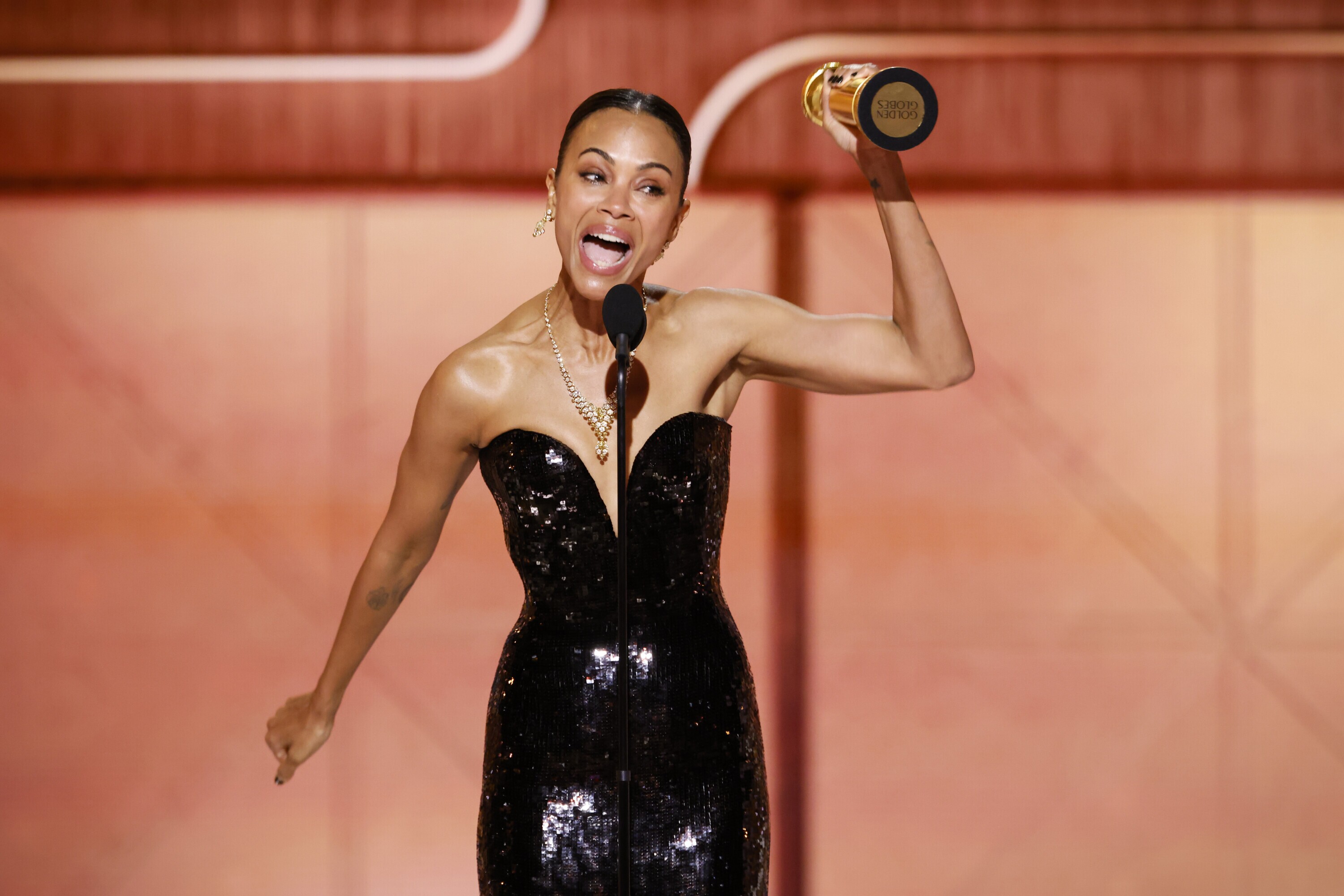 Zoe Saldaña accepts the award for best supporting actress in a motion picture at the Golden Globes Sunday night for her role in the film <em>Emilia Pérez. </em>