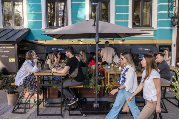 People eat dinner in Yevhen Klopotenko's restaurant 100 rokiv tomu vpered in Kyiv on Aug. 14.
